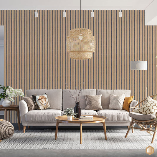 Un salon moderne comprend un canapé beige, des coussins assortis, une table basse ronde en bois, un tapis à motifs et un mur d'accent avec Acoupanel™ Panneau Tasseau Acoustique en Chêne Naturel 3 Faces - Feutrine Grise. Une lampe suspendue tissée est suspendue au-dessus.