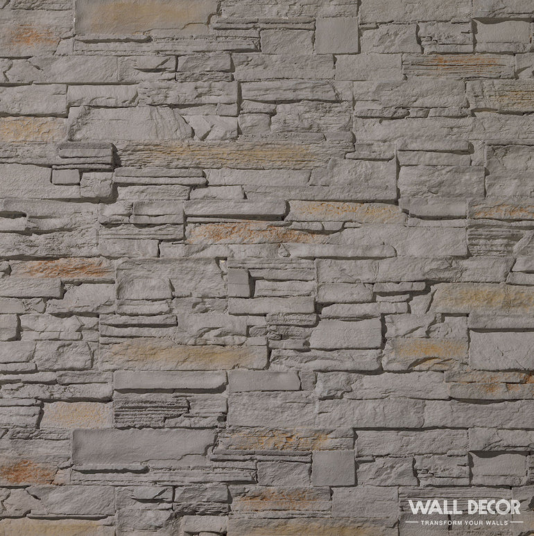 Le Panespol™ Parement Pierre Grise - Pizarra présente un aspect texturé et irrégulier de briques de pierre grises et marron clair, idéal pour une décoration murale moderne. 