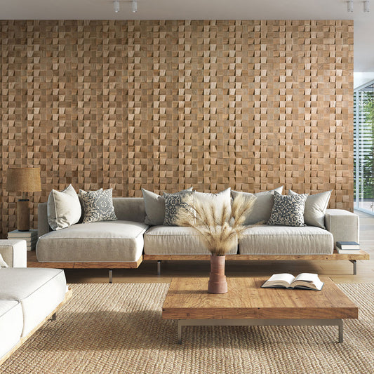 Un salon moderne présentant le Panneau mural bois Domus de Wood & Wall Decor™, des canapés sectionnels beige clair avec des coussins à motifs, et une table basse en bois surmontée d'un vase d'herbes séchées.